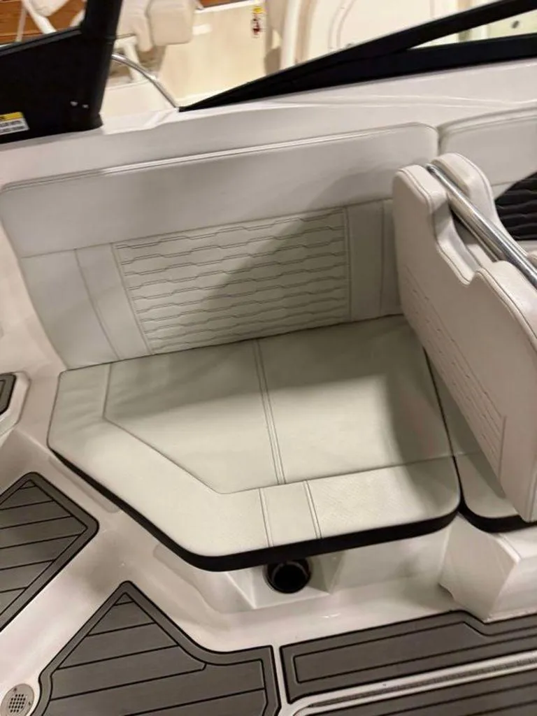 Slide: The Image of 2023 Sea Ray SPX 230 boat interior seating with white upholstery and modern design. - 7
