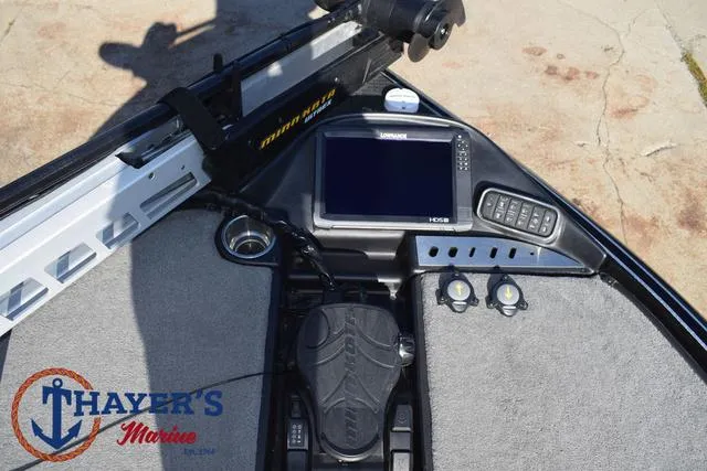 Slide: The Image of 2018 Triton 21 TrX boat dashboard with electronics and foot pedal controls. - 12