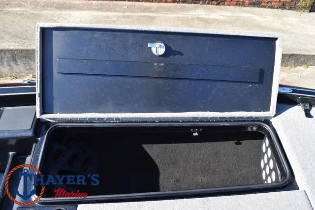 Slide: The Image of Open storage compartment of 2018 Triton 21 TrX boat. - 15