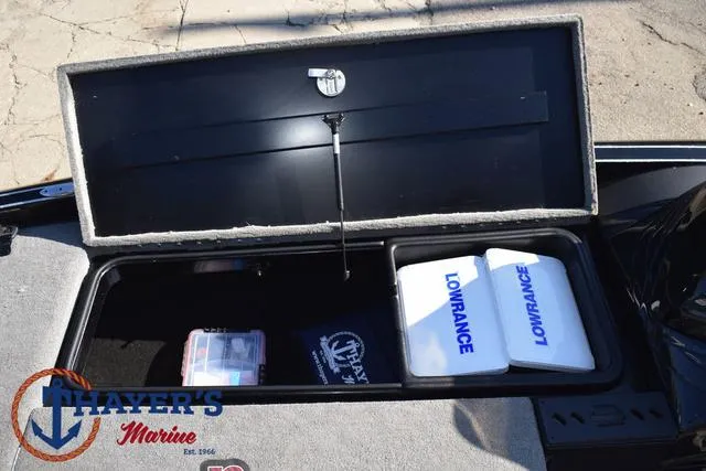 Slide: The Image of Open storage compartment in a 2018 Triton 21 TrX boat with Lowrance equipment. - 17