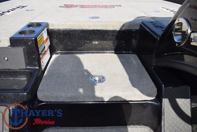 Slide: The Image of 2018 Triton 21 TrX boat deck with carpet and storage compartment. - 19