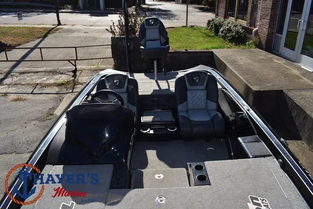 Slide: The Image of 2018 Triton 21 TrX boat interior with seating and steering, displayed at Thayer's Marine. - 22