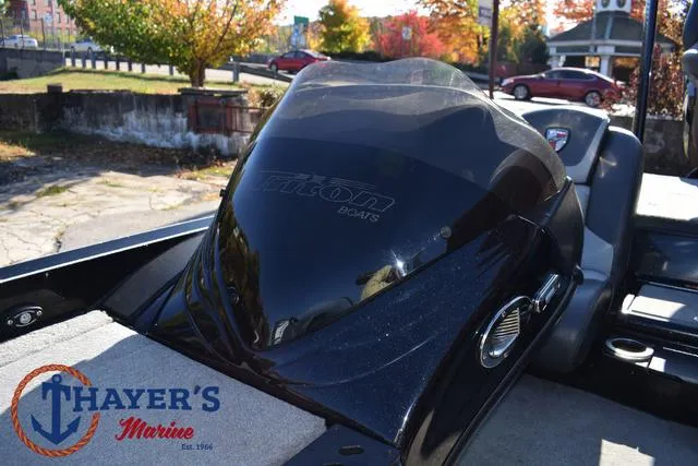 Slide: The Image of 2018 Triton 21 TrX boat at Thayer's Marine, featuring sleek black design. - 28