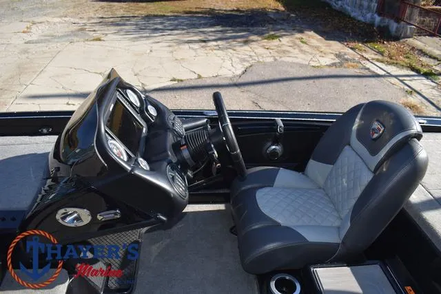 Slide: The Image of 2018 Triton 21 TrX boat interior with steering wheel and dashboard, featuring Thayer's Marine logo. - 29