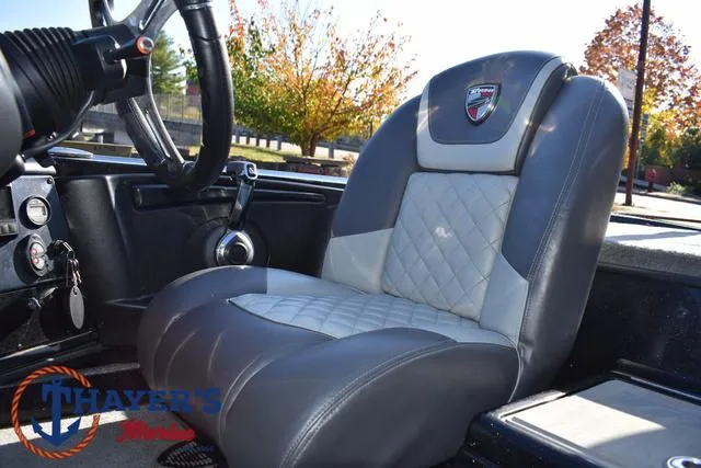 Slide: The Image of 2018 Triton 21 TrX boat interior with gray and white leather seat. - 32