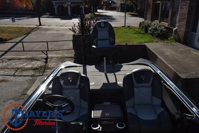 Slide: The Image of 2018 Triton 21 TrX boat interior with seating and steering wheel, Mayer's Marine logo visible. - 33
