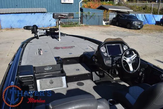 Slide: The Image of 2018 Triton 21 TrX boat interior with steering console and fishing deck. - 38