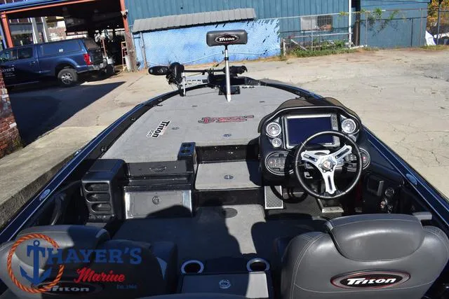 Slide: The Image of 2018 Triton 21 TrX boat interior with steering console and seating. - 39