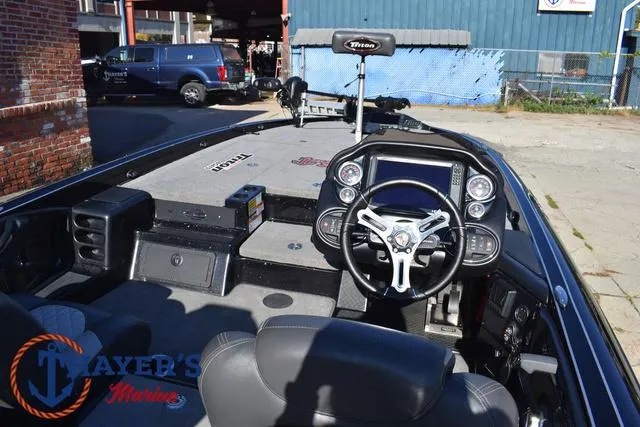 Slide: The Image of 2018 Triton 21 TrX boat interior with steering wheel and dashboard controls. - 40