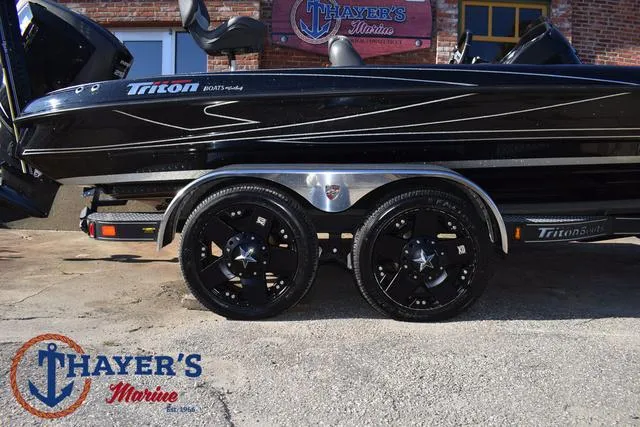 Slide: The Image of 2018 Triton 21 TrX boat on trailer at Thayer's Marine dealership. - 6
