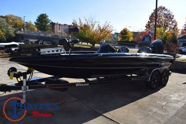 Slide: The Image of 2018 Triton 21 TrX bass boat on trailer at Thayer's Marine dealership. - 8