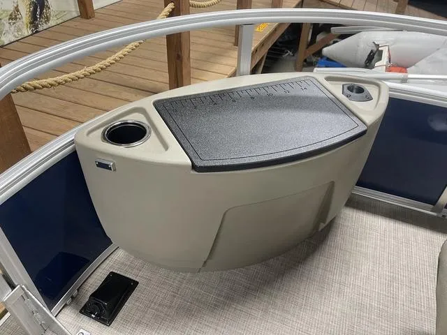 Slide: The Image of 2025 Sun Tracker Bass Buggy 18 DLX pontoon boat interior with seating and steering console. - 11