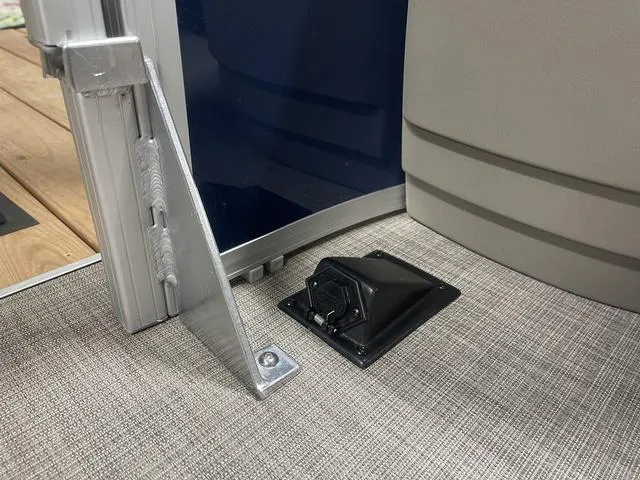 Slide: The Image of 2025 Sun Tracker Bass Buggy 18 DLX interior with beige seating and steering console. - 12