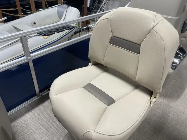 Slide: The Image of 2025 Sun Tracker Bass Buggy 18 DLX pontoon boat seating in showroom. - 13