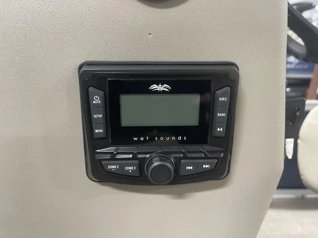 Slide: The Image of 2025 Sun Tracker Bass Buggy 18 DLX with Mercury outboard motor in showroom. - 15