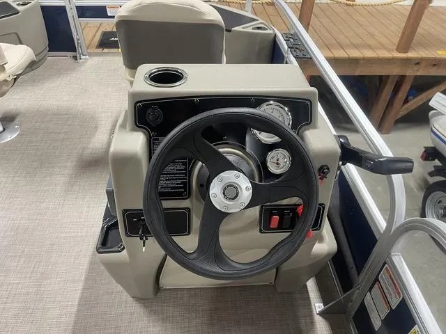 Slide: The Image of 2025 Sun Tracker Bass Buggy 18 DLX storage compartment with accessories. - 18