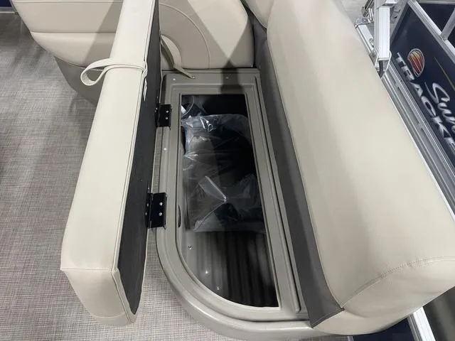 Slide: The Image of 2025 Sun Tracker Bass Buggy 18 DLX storage compartment with cup holder and control panel. - 22