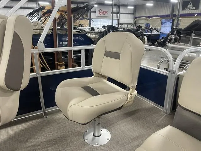 Slide: The Image of 2025 Sun Tracker BASS BUGGY® 18 DLX boat seat in showroom, featuring beige upholstery. - 24