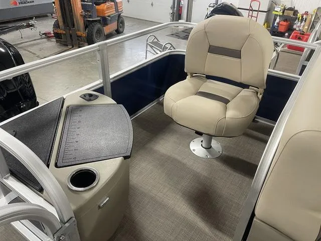 Slide: The Image of 2025 Sun Tracker BASS BUGGY® 18 DLX interior with beige seating and fishing station. - 25