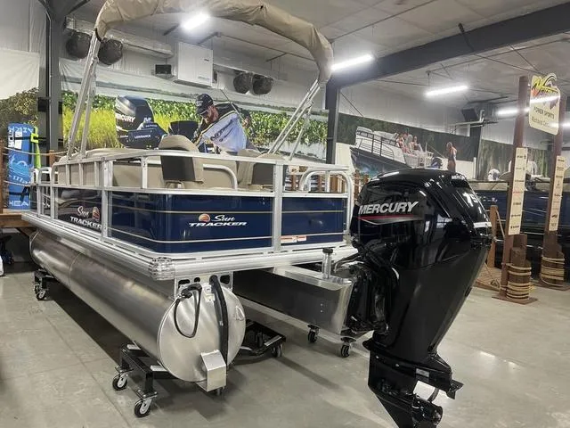 Slide: The Image of 2025 Sun Tracker BASS BUGGY® 18 DLX pontoon boat with Mercury outboard motor in showroom. - 33