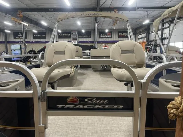 Slide: The Image of 2025 Sun Tracker Bass Buggy 18 DLX pontoon boat in showroom. - 4