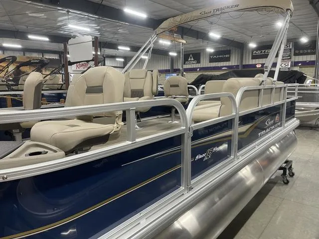 Slide: The Image of 2025 Sun Tracker Bass Buggy 18 DLX pontoon boat in a workshop setting. - 6