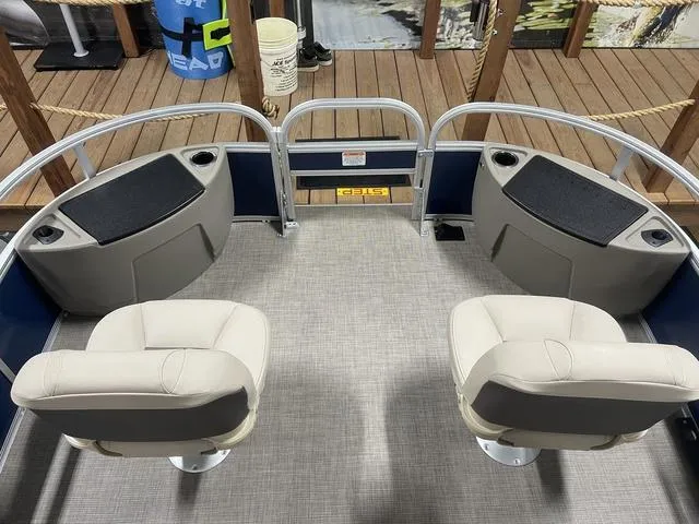Slide: The Image of 2025 Sun Tracker Bass Buggy 18 DLX pontoon boat in indoor showroom. - 7