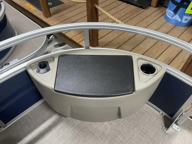 Slide: The Image of 2025 Sun Tracker Bass Buggy 18 DLX pontoon boat in a showroom. - 8