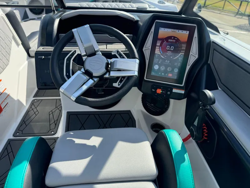 Slide: The Image of 2023 Tigé 24RZX boat dashboard with touchscreen and modern steering wheel. - 16