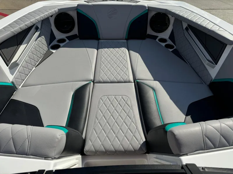 Slide: The Image of 2023 Tigé 24RZX boat interior with quilted gray and teal seating. - 18