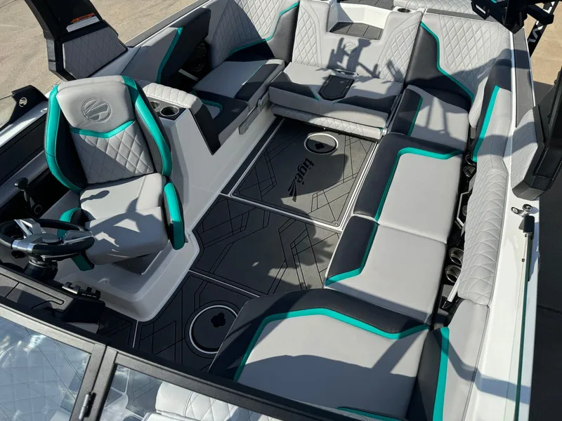 Slide: The Image of 2023 Tigé 24RZX boat interior with gray and teal seating, modern design. - 19
