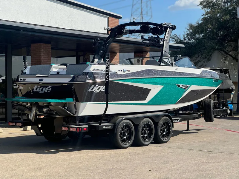 Slide: The Image of 2023 Tigé 24RZX boat on trailer, featuring sleek design and vibrant teal accents. - 3