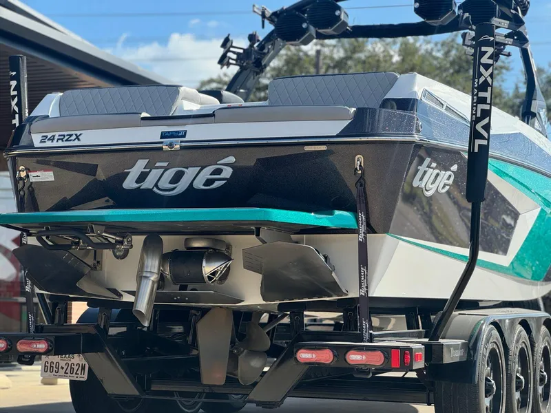 Slide: The Image of 2023 Tigé 24RZX boat on trailer, rear view, showcasing sleek design and branding. - 4