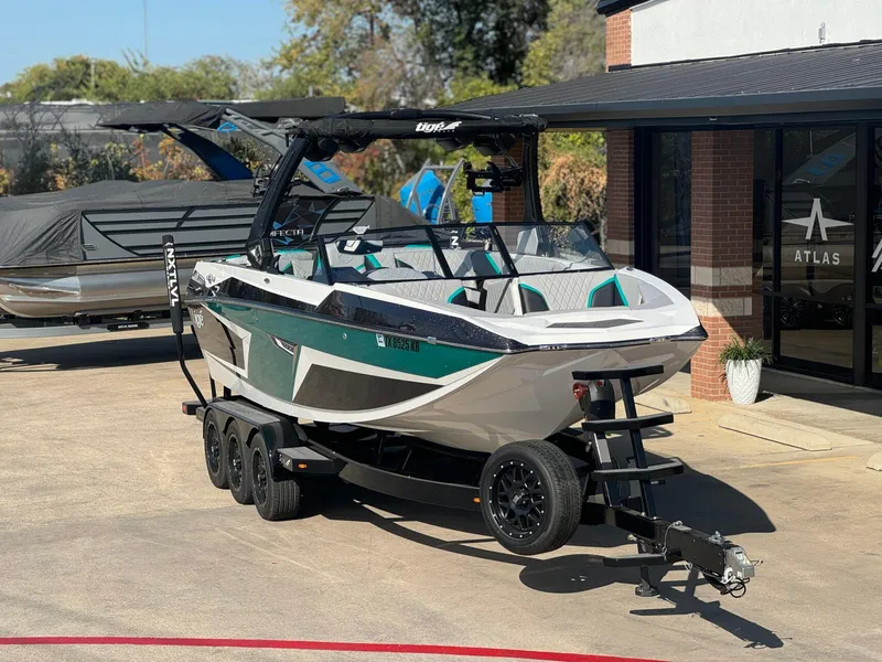 Slide: The Image of 2023 Tigé 24RZX boat on trailer, parked outside dealership, showcasing sleek design and modern features. - 5