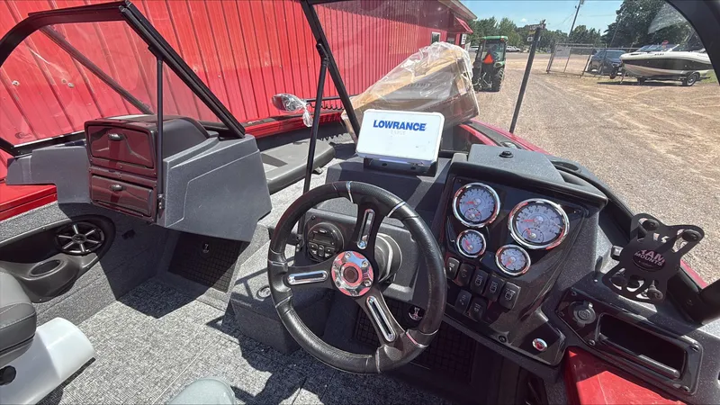 Slide: The Image of 2025 Tracker Targa V-19 Combo boat dashboard with steering wheel and Lowrance display. - 4