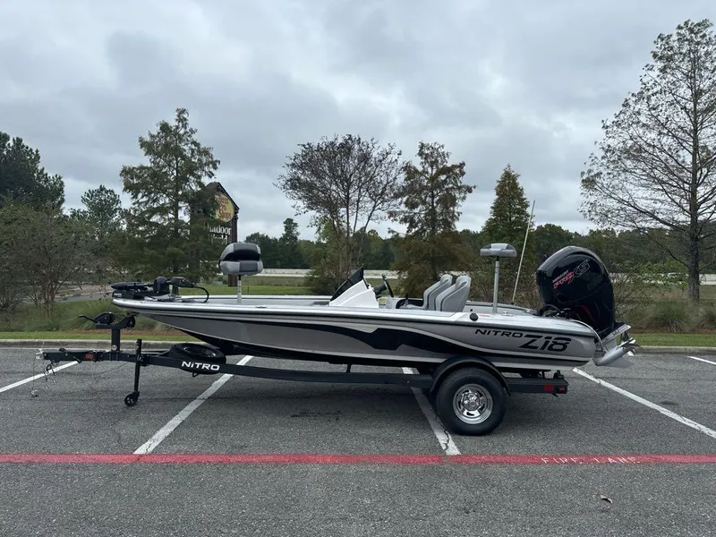Slide: The Image of 2025 Nitro Z18 boat parked outdoors, side view, on a trailer. - 0
