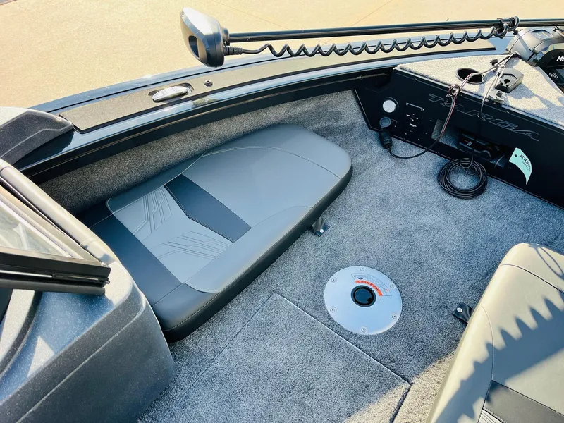 Slide: The Image of 2025 Tracker Targa V-18 Combo boat interior with seating and control panel. - 11