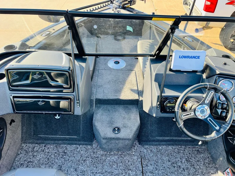 Slide: The Image of 2025 Tracker Targa V-18 Combo boat interior with steering wheel and Lowrance display. - 17