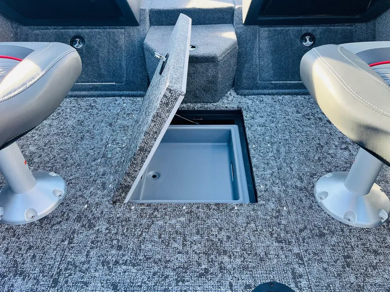 Slide: The Image of 2025 Tracker Targa V-18 Combo boat interior with open storage compartment. - 21
