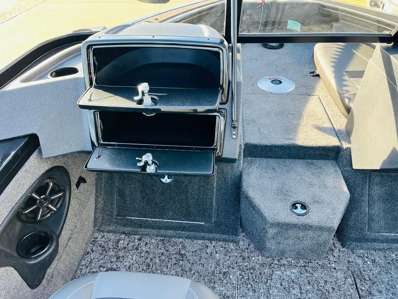 Slide: The Image of 2025 Tracker Targa V-18 Combo boat interior with storage compartments and seating. - 23