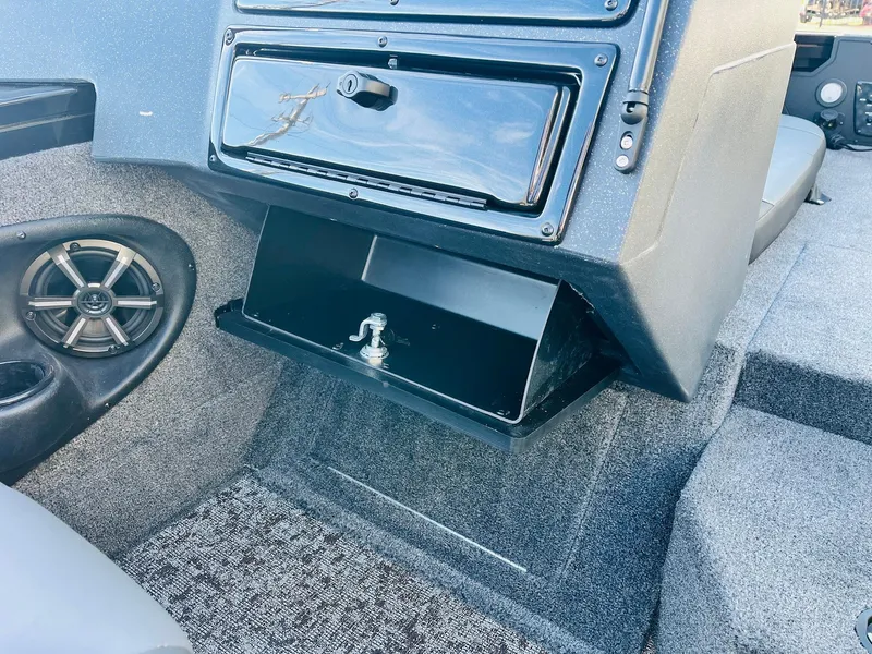 Slide: The Image of 2025 Tracker Targa V-18 Combo boat interior with storage compartment and speaker. - 24