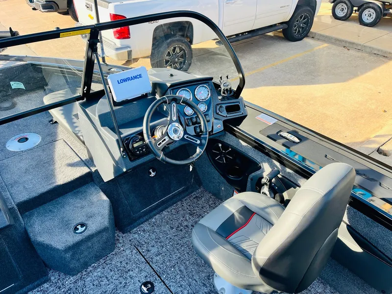 Slide: The Image of 2025 Tracker Targa V-18 Combo boat interior with steering wheel and navigation system. - 26