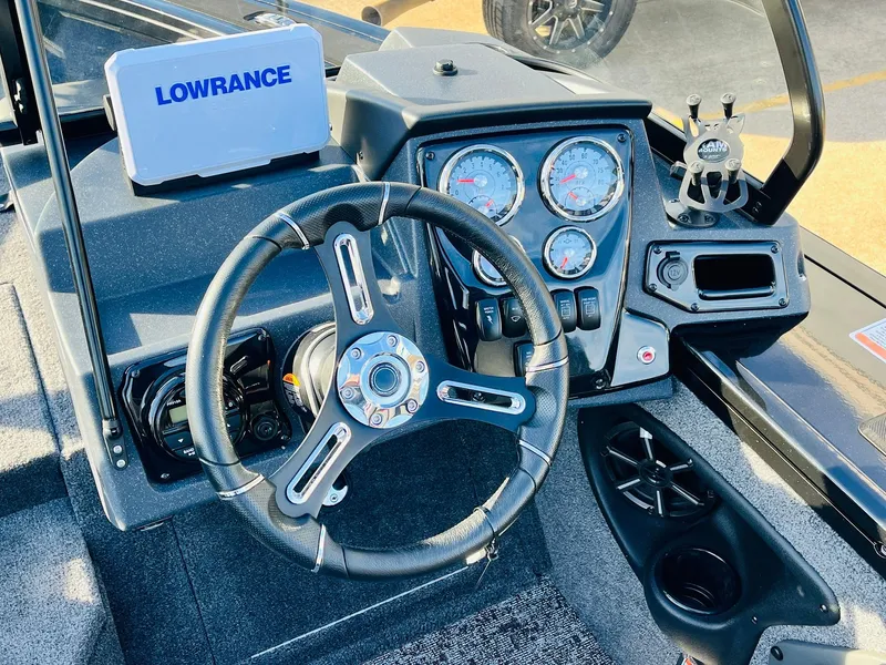Slide: The Image of 2025 Tracker Targa V-18 Combo boat dashboard with Lowrance system and steering wheel. - 29