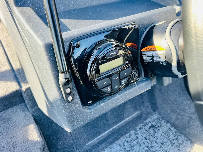 Slide: The Image of 2025 Tracker Targa V-18 Combo boat dashboard with control panel and radio system. - 30