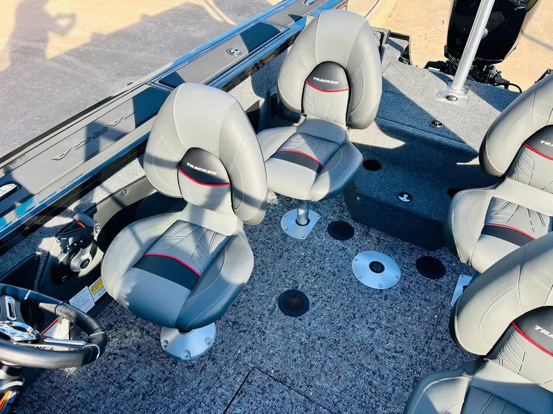 Slide: The Image of 2025 Tracker Targa V-18 Combo boat interior with gray seating and carpeted flooring. - 33