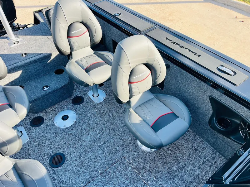 Slide: The Image of 2025 Tracker Targa V-18 Combo boat interior with gray and red seats. - 34