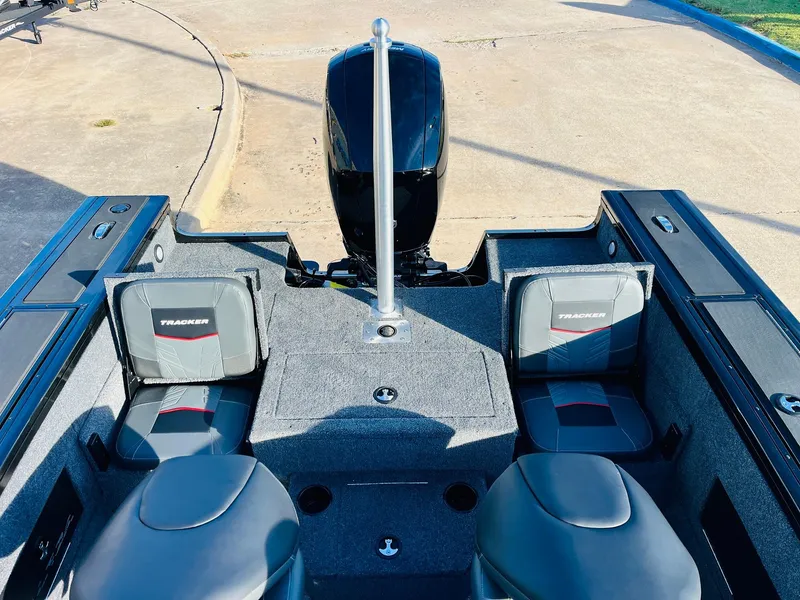 Slide: The Image of 2025 Tracker Targa V-18 Combo boat interior with seating and motor. - 35
