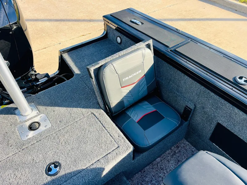 Slide: The Image of 2025 Tracker Targa V-18 Combo boat interior with cushioned seating and storage compartments. - 36