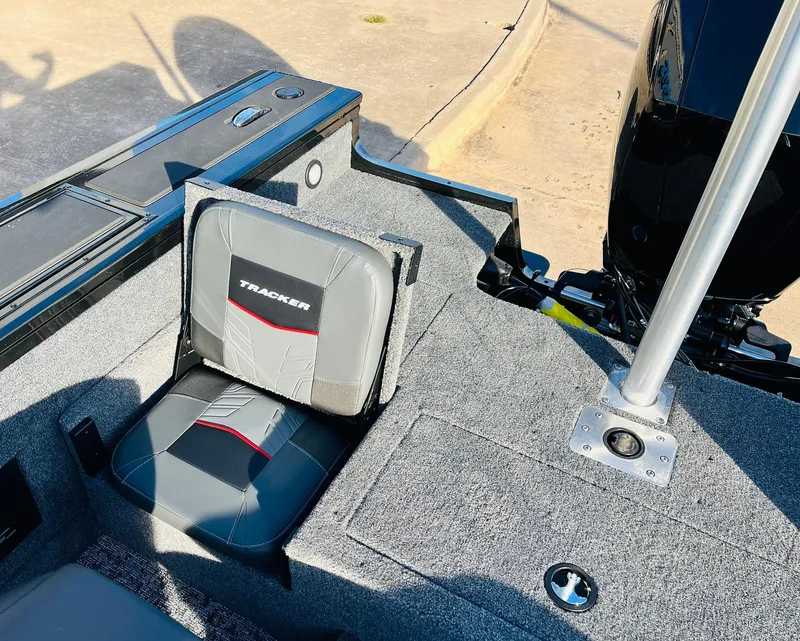 Slide: The Image of 2025 Tracker Targa V-18 Combo boat interior with gray seating and motor. - 37