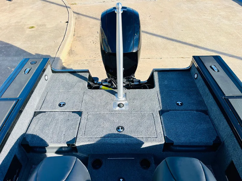 Slide: The Image of 2025 Tracker Targa V-18 Combo boat interior with motor and seating. - 45